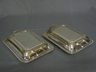 A pair of rectangular silver plated twin handled entree dishes and covers by Mappin & Webb