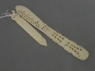 A pierced ivory paper knife with folding blade and 1 other