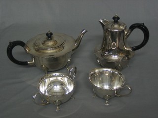 A silver plated 4 piece tea service comprising circular teapot, hotwater jug, sugar bowl and cream jug