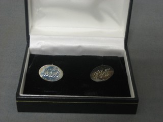 A pair of engraved silver cufflinks, cased