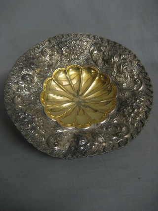 A circular embossed Continental silver bowl raised on panel supports, the base marked 900 SH, 23 ozs