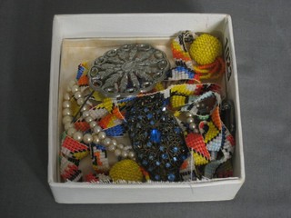 A section of native bead work and a small collection of costume jewellery including 4 brooches