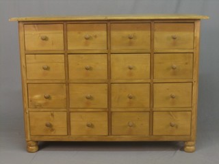 A pine chest fitted 20 short drawers raised on bun feet 48"