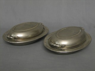 A pair of oval silver plated twin handled entree dishes and covers