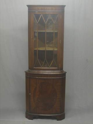 A Georgian style mahogany double corner cabinet with moulded and dentil cornice, the interior fitted adjustable shelves the base fitted shelves enclosed by panelled doors, raised on bracket feet 23"
