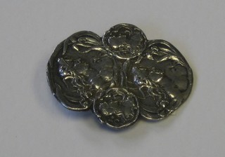 An Art Nouveau embossed silver brooch decorated ladies