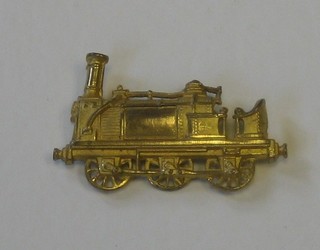 A gilt metal collar dog in the form of a steam locomotive