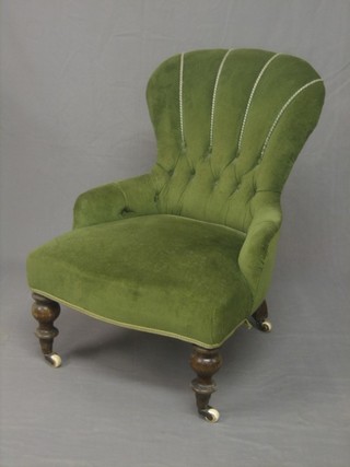 A mahogany iron framed tub back nursing chair, upholstered in green material