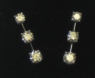 A pair of ladies diamond earrings set 3 graduated diamonds approx 1.30ct