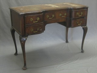 A Georgian style mahogany writing table of serpentine outline with crossbanded top,  fitted 1 long drawer flanked by 2 short drawers, raised on cabriole supports 41" 