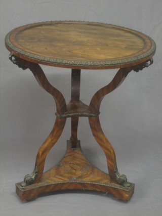 A French Empire period circular rosewood and Ormolu mounted 2 tier occasional table, raised on cabriole supports with triform base 25"