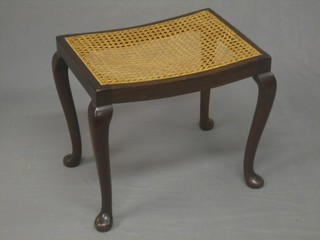 A Queen Anne style walnut dressing table stool with woven cane seat, raised on cabriole supports 19"