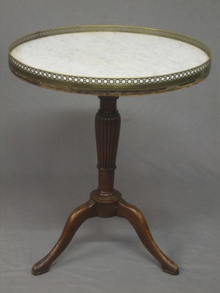A 19th Century Continental circular marble and walnut occasional table with white veined marble top and pierced brass gallery, raised on a carved walnut turned and fluted tripod base 23"