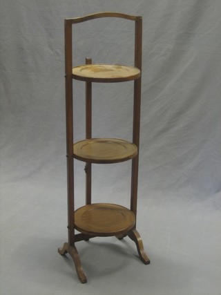 A circular mahogany 3 tier folding cake stand