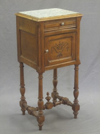 A 19th Century French walnut bedside cabinet with a grey veined marble top, drawer and cupboard, raised on turned supports 15"