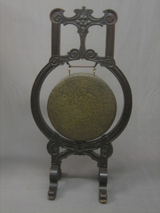 An Eastern bronze gong raised on a carved stand