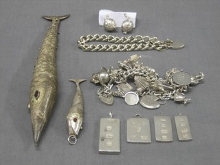 A "silver" model of an articulated fish 8", 1 other 3", a silver charm bracelet hung numerous charms, 4 small silver ingots, 1 other silver charm bracelet and a pair of football shaped earrings
