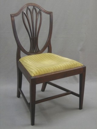 A 19th Century mahogany Hepplewhite shield back dining chair with upholstered drop in seat, raised on square tapering supports