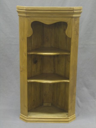A pine hanging corner cabinet with moulded cornice, fitted 2 shelves 18"