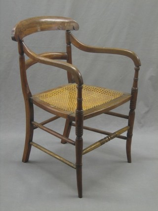 A 19th Century mahogany bar back open arm chair with woven cane seat, raised on turned supports