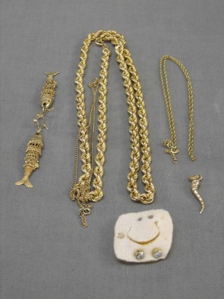 A gilt metal multi link chain, 2 gilt metal necklaces, 2 gilt metal earrings in the form of articulated fish, a gold pendant, 1 other gilt metal chain and 2 pairs of earrings set white stones