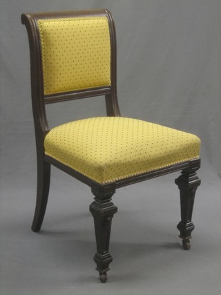 A Victorian carved oak show frame chair upholstered in yellow material, raised on square tapering supports