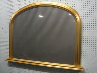 A Victorian style D shaped plate over mantel mirror contained in a decorative gilt frame 38"