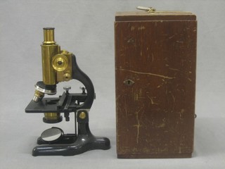 A microscope by F E Becker & Co London no. 1372 contained in a wooden case