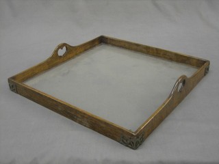 An Art Nouveau square oak and plate glass twin handled tray 16"