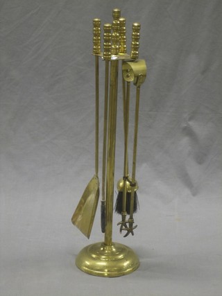 A modern 4 piece brass fireside companion set