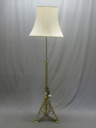 A 19th Century brass adjustable oil lamp converted for use as an electric standard lamp