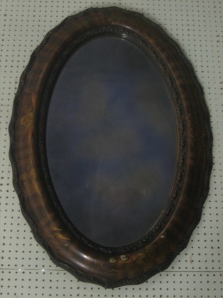 An oval plate wall mirror contained in a chinoiserie style frame 35"