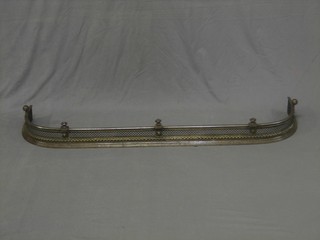 A handsome 19th Century pierced and polished steel and brass fire curb 58"
