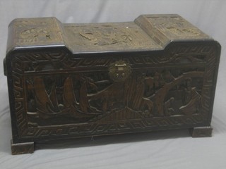 A carved camphor coffer with hinged lid, raised on bracket feet 39"