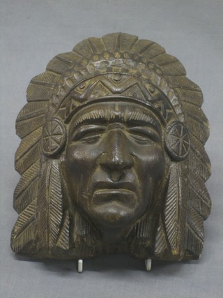 A carved wooden wall mask in the form of a Red Indian
