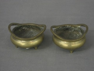 A pair of Eastern bronze circular miniature twin handled cauldrons, the base with seal mark 2"