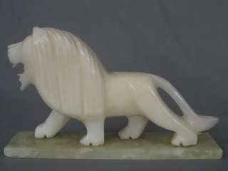 A carved alabaster figure of a walking lion 12"