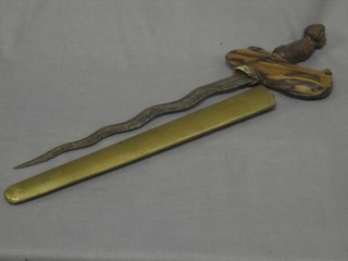 A Kris with 12" blade, carved hilt