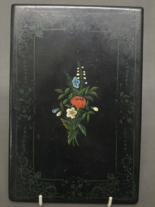 A Russian painted and lacquered book cover with floral decoration 9" x 6"