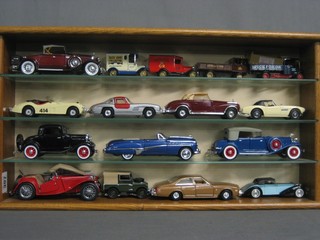 16 various model cars contained in an oak display cabinet