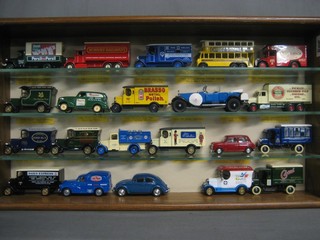 21 various model cars contained in an oak display cabinet