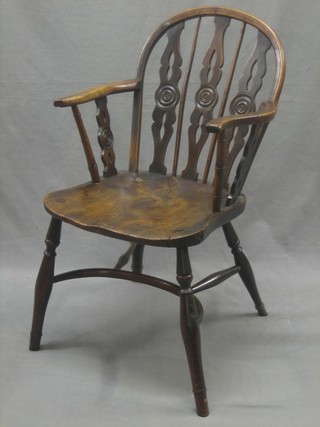 An 18th/19th Century elm Windsor kitchen carver chair with solid elm seat, raised on turned supports with cow horn stretcher
