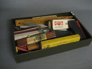 A metal tray containing a collection of various pencils, drawing instruments etc
