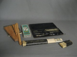 A geometry set, a slide rule, a triangular wooden gauge marked G Lea & Sons Portsmouth, 1 other gauge and various drawing instruments