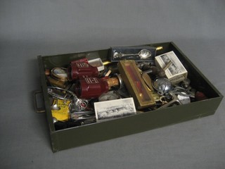 A rectangular metal draw containing a collection of various curios etc