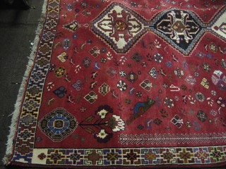 A contemporary red ground Kashkai with 5 octagons to the centre and with floral decoration 104" x 72"
