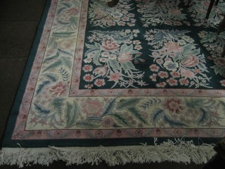 A green ground and floral patterned Chinese carpet 144" x 108"