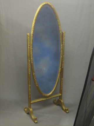 A 19th Century oval bevelled plate cheval mirror contained in a gilt frame and stand 55"