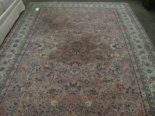 A pink ground machine made Persian carpet with floral decoration 120" x 79"