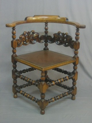 A carved oak corner chair with bobbin turned stretchers